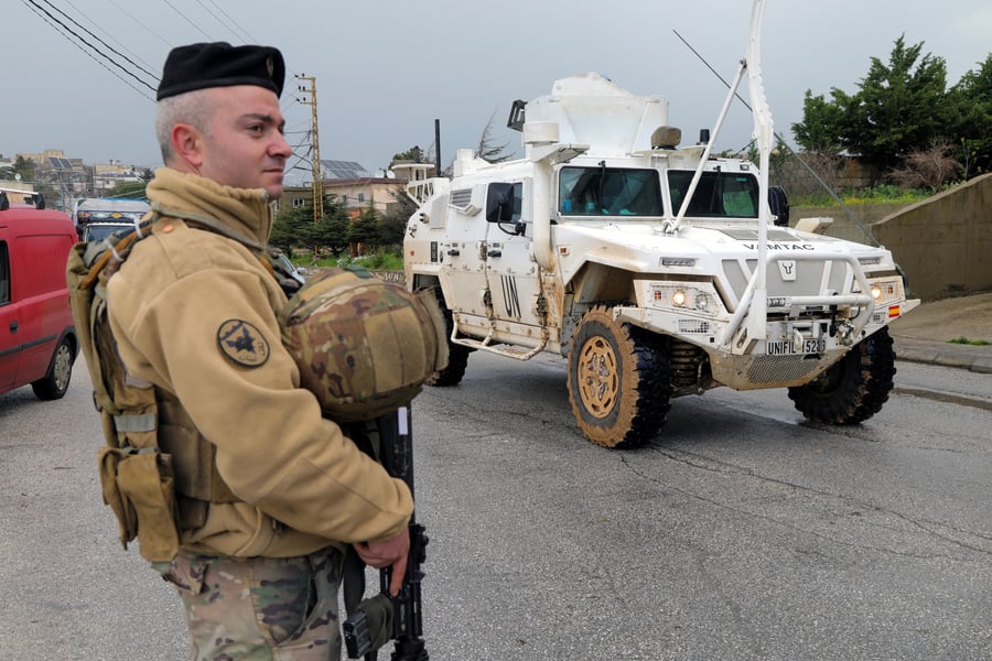 UNIFIL peacekeeping vehicle passing a Lebanese soldier in southern Lebanon amid Israeli strikes