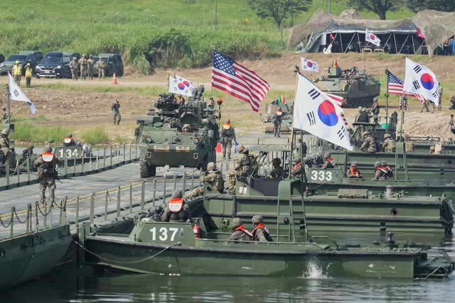 US Army Stryker Combat Team vehicles crossing a bridge on the Namhan River during military exercises in South Korea