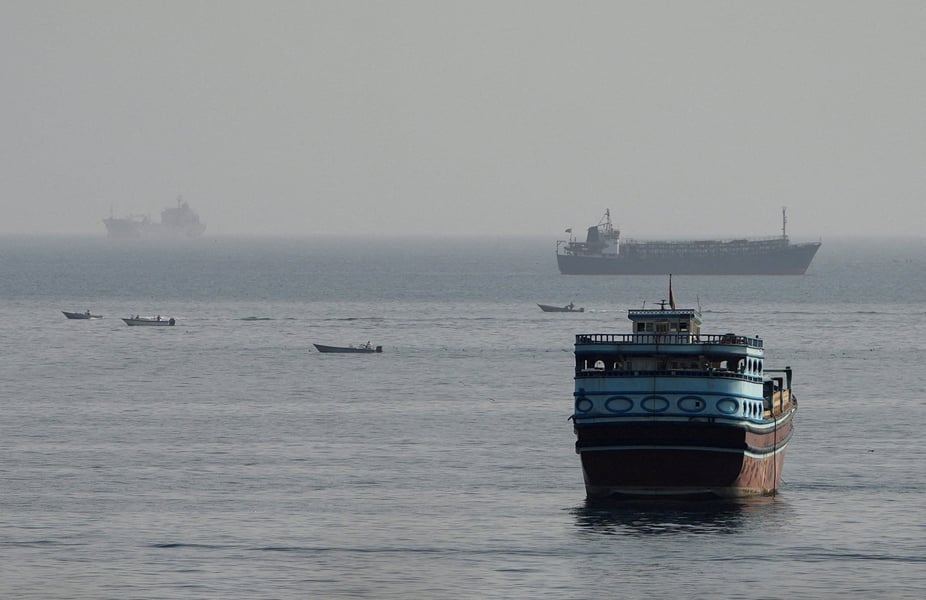Commercial vessels transiting through the Strait of Hormuz as seen from Musandam peninsula, Oman