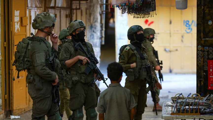 Israeli military forces at entrance of besieged Palestinian village in occupied West Bank
