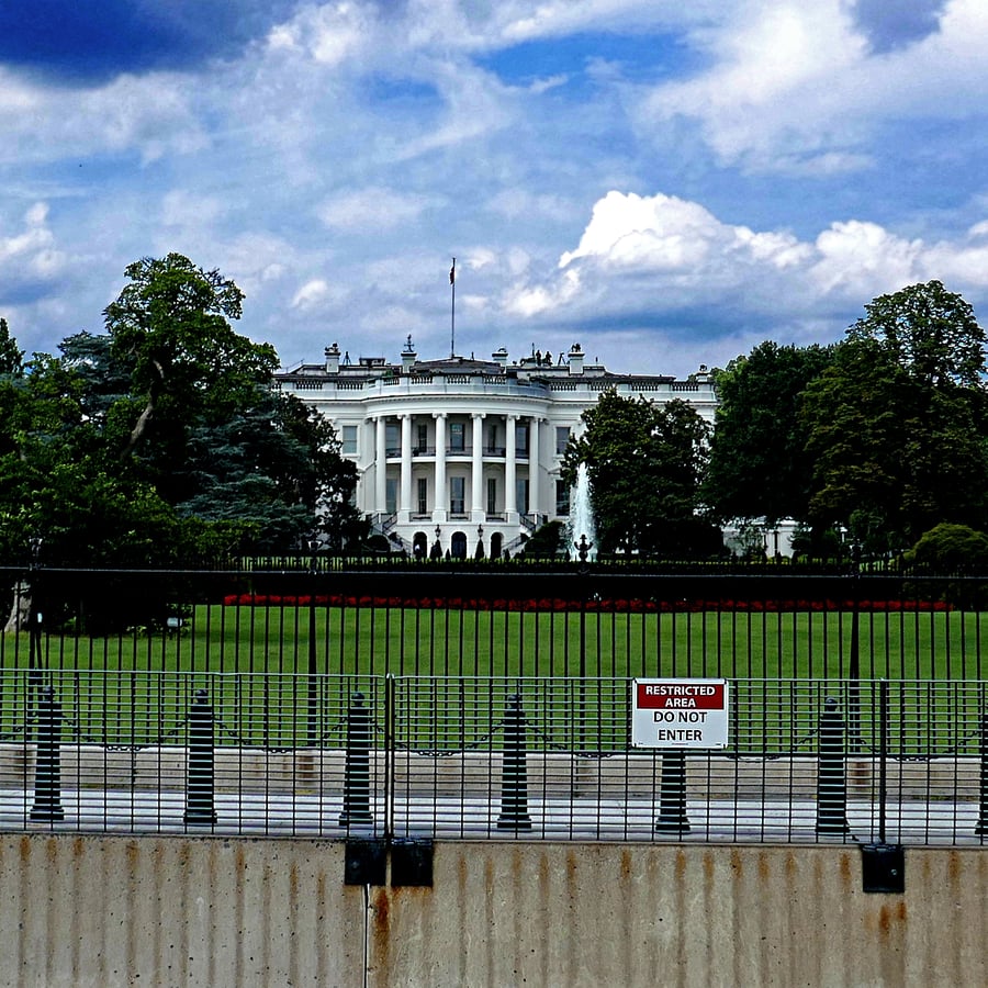White House behind security fence with Restricted Area Do Not Enter sign, Washington DC
