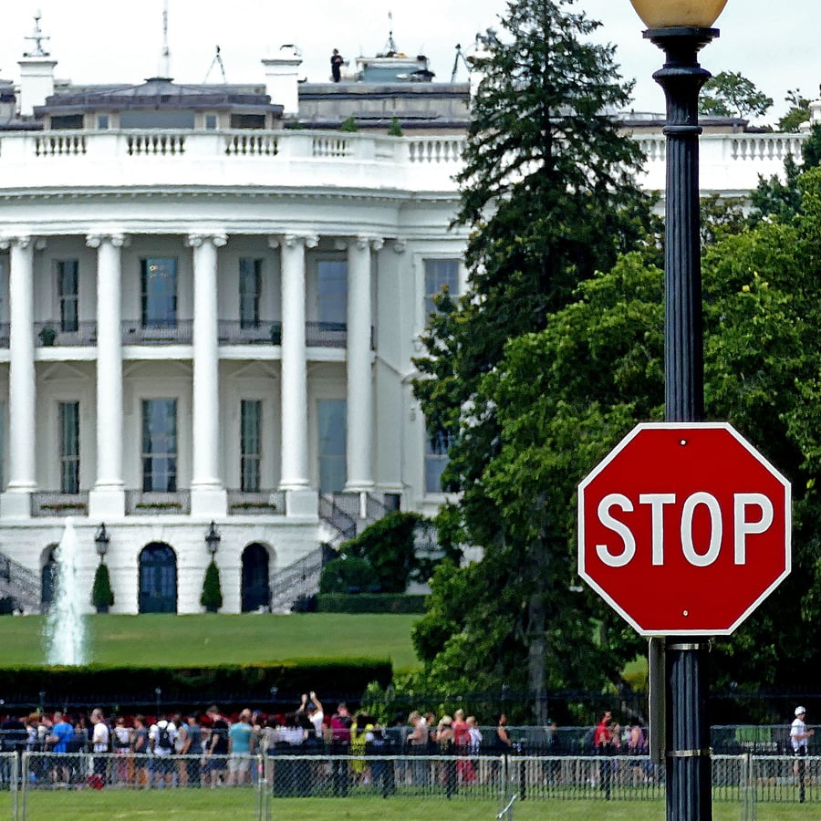 White House exterior with security STOP sign in foreground, Washington DC