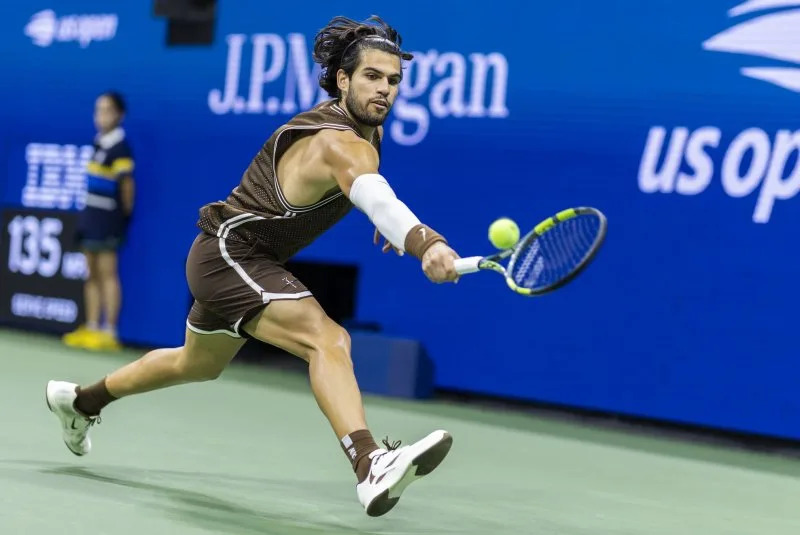 Carlos Alcaraz playing against Jaime Faria at the 2026 US Open second round on Arthur Ashe Stadium