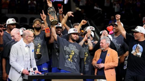 Jalen Brunson holding the Bill Russell Trophy after winning the 2026 NBA Finals MVP award