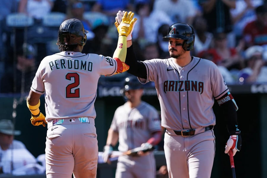 Diamondbacks players celebrate after scoring five runs in the 10th inning to beat the Kansas City Royals