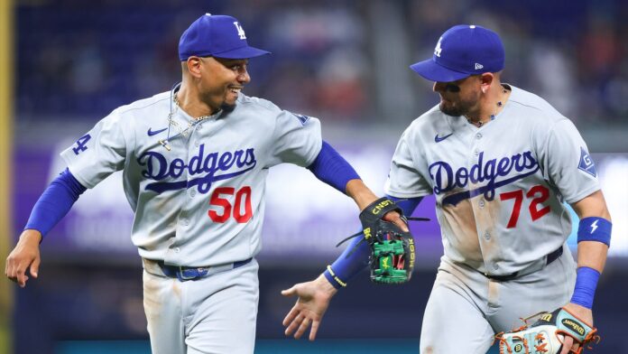 Los Angeles Dodgers players celebrate clinching their 14th consecutive MLB playoff berth at Great American Ball Park in Cincinnati