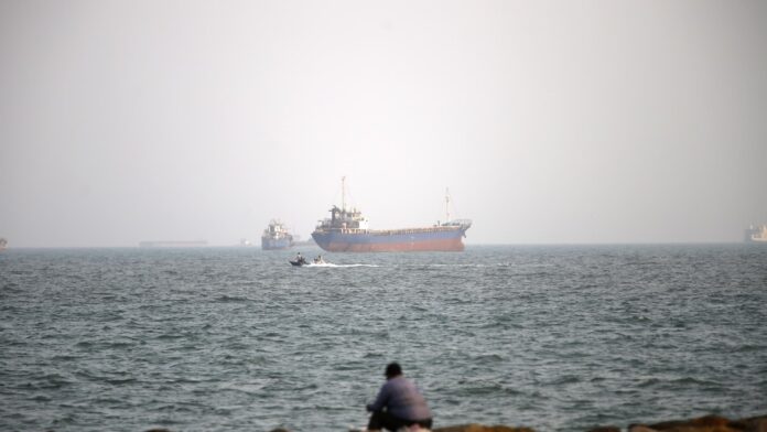 Oil traders at a trading desk monitoring crude oil prices as Iran's foreign minister proposes reopening the Strait of Hormuz