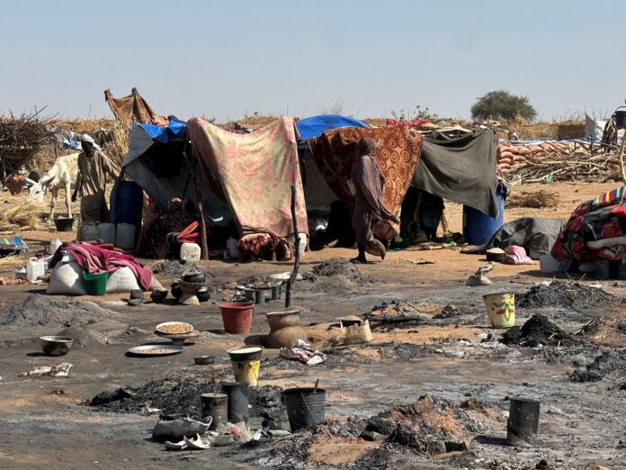 Displaced Sudanese civilians amid destruction from the RSF campaign against El-Fasher