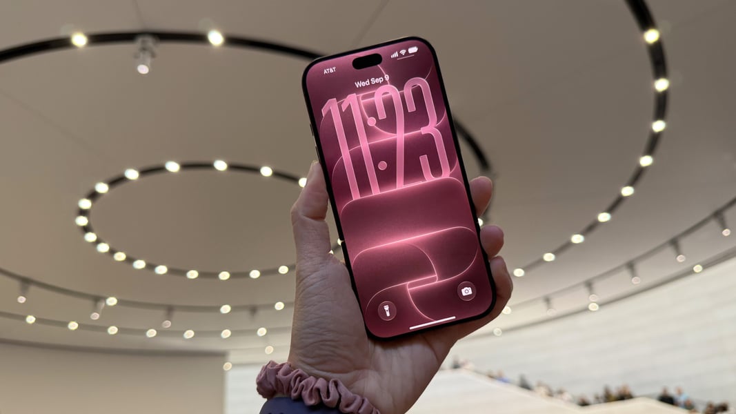 iPhone 18 Pro held in hands showing iOS 27 Siri AI interface