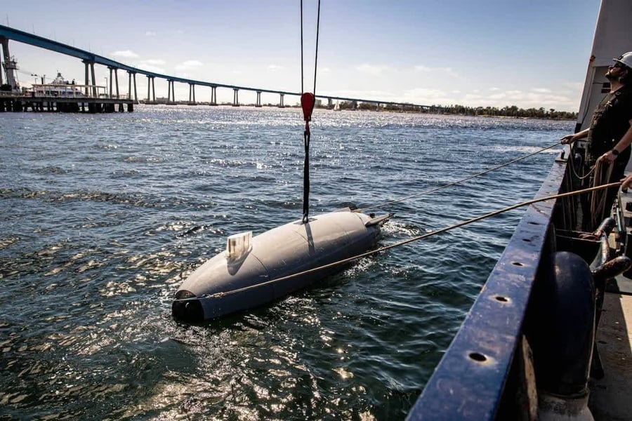 Iranian IRGC personnel display seized US underwater drone from the Strait of Hormuz
