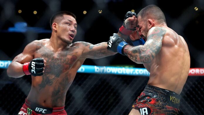 Joshua Van connects with a right hand against Alexandre Pantoja in their UFC 331 flyweight title rematch at Crypto.com Arena