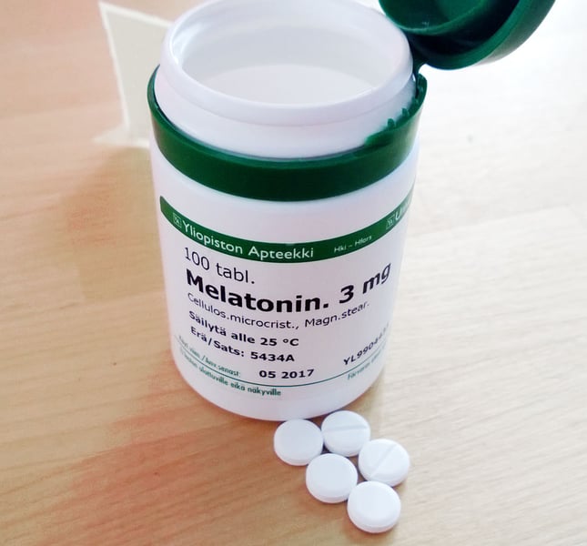 Melatonin supplement prescription bottle on a pharmacy counter, related to the new study linking long-term use to higher heart failure risk