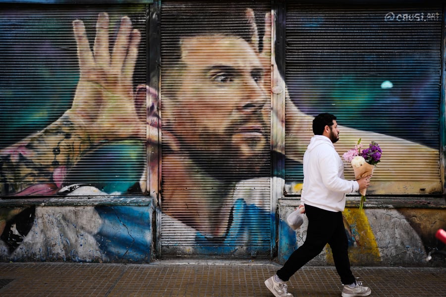Argentine football fans applaud during the 10th-minute tribute to Lionel Messi