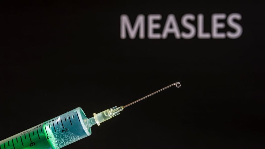 Medical professional administering a vaccine injection, representing the Pennsylvania measles outbreak that has claimed three lives