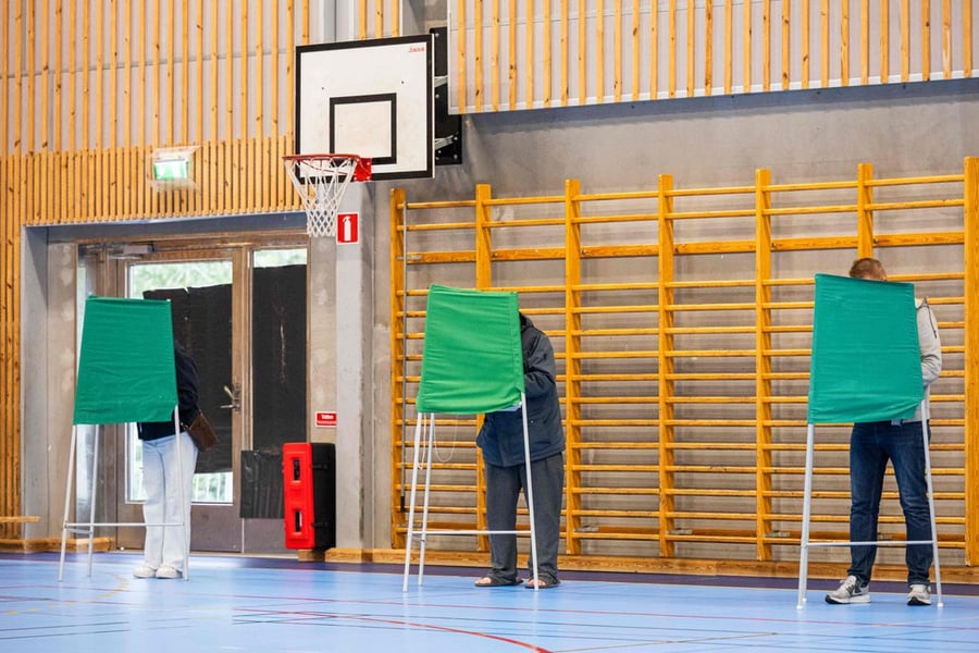 Swedish voters at polling station during the 2026 Riksdag parliamentary elections as exit polls show centre-left leading
