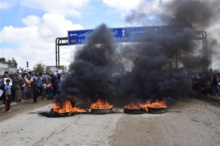 Syrian protesters burning tires during fuel price demonstrations