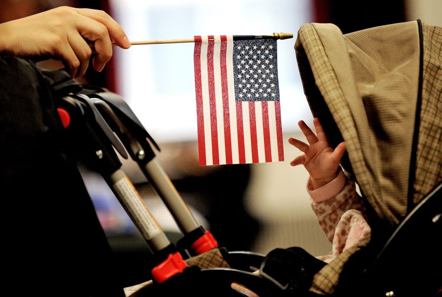 Baby wrapped in US flag representing birthright citizenship rights blocked by federal court ruling
