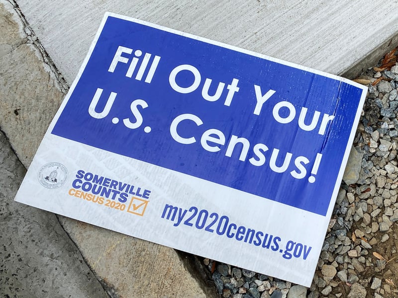 Census Bureau forms with U.S. flag backdrop as Trump proposes excluding non-citizens from 2030 apportionment count