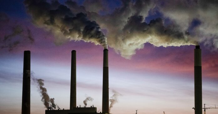 Coal-fired power plant smokestacks emitting smoke in the United States