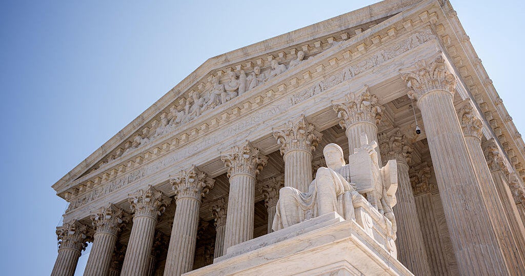 Supreme Court building with U.S. flag as Trump administration files emergency application over SAVE voter database