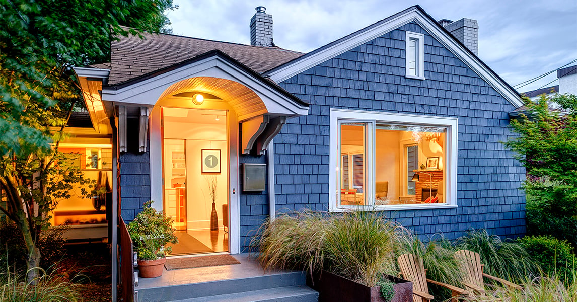 Illuminated blue shingled house representing US housing market conditions affecting mortgage quote rates in September 2026