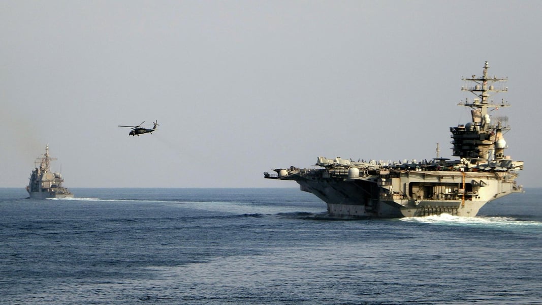USS Dwight D. Eisenhower aircraft carrier and escorting destroyer transit the Strait of Hormuz during the Iran-US war