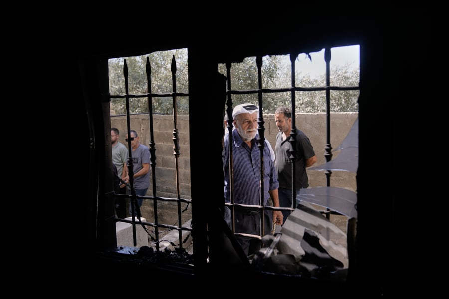 Palestinians examine damage to a mosque in Bazariya village after a settler arson attack on September 2 2026