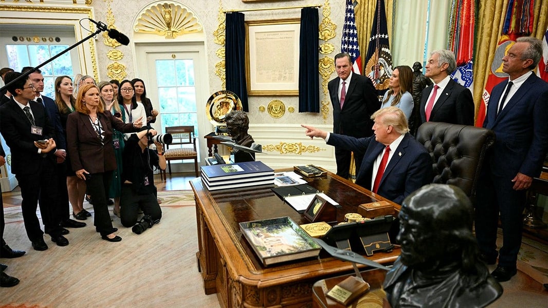 Television news reporters and cameras at the White House after major networks suspended press pool coverage in protest of the media ban