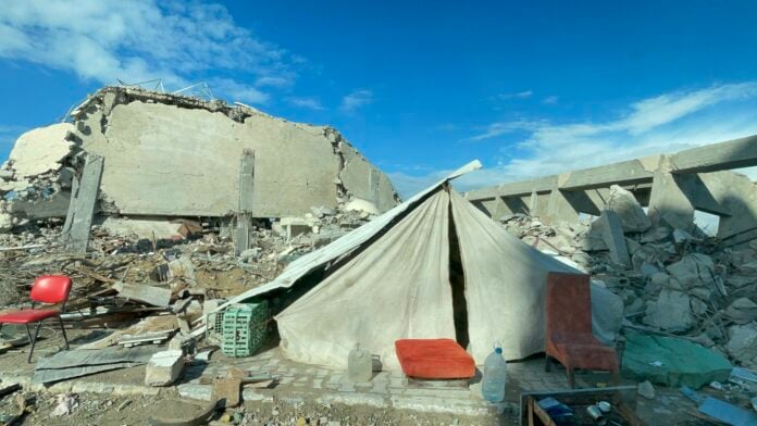A tent set up by a homeowner among the rubble of his house after an Israeli airstrike in Gaza