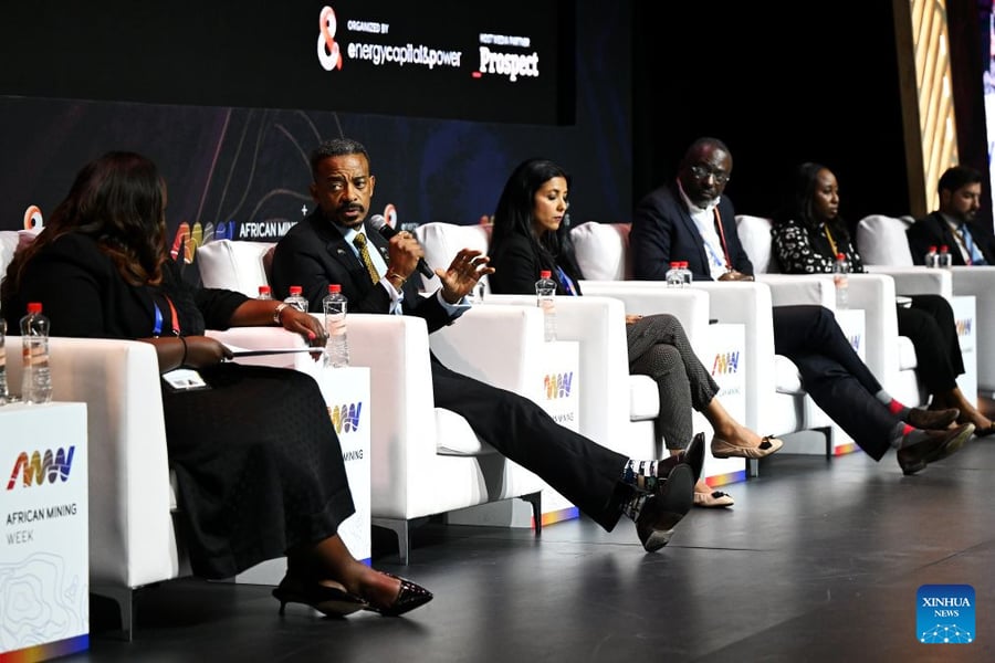 Panelists seated in white armchairs on stage during a discussion at African Mining Week 2026 in Cape Town