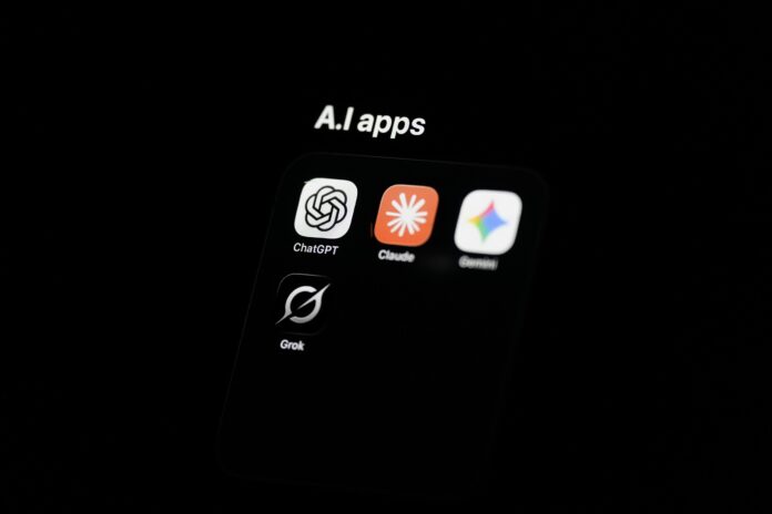 A phone folder labelled A.I apps showing ChatGPT, Claude, Gemini and Grok icons on a dark screen