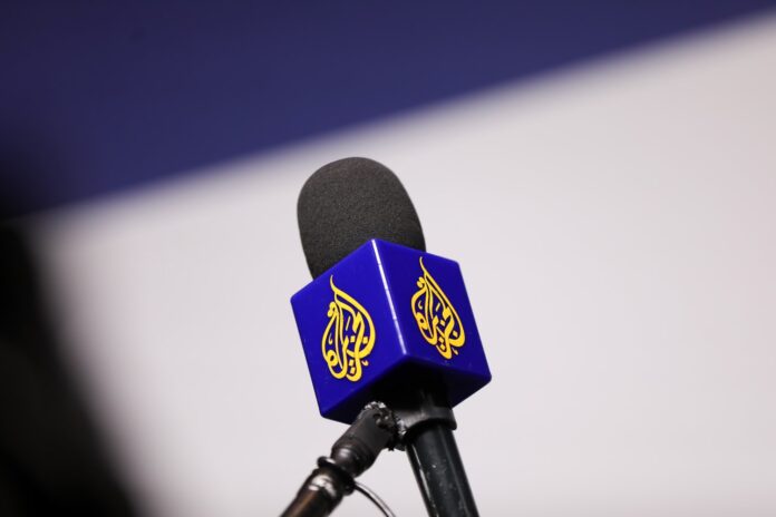 A microphone fitted with the Al Jazeera logo
