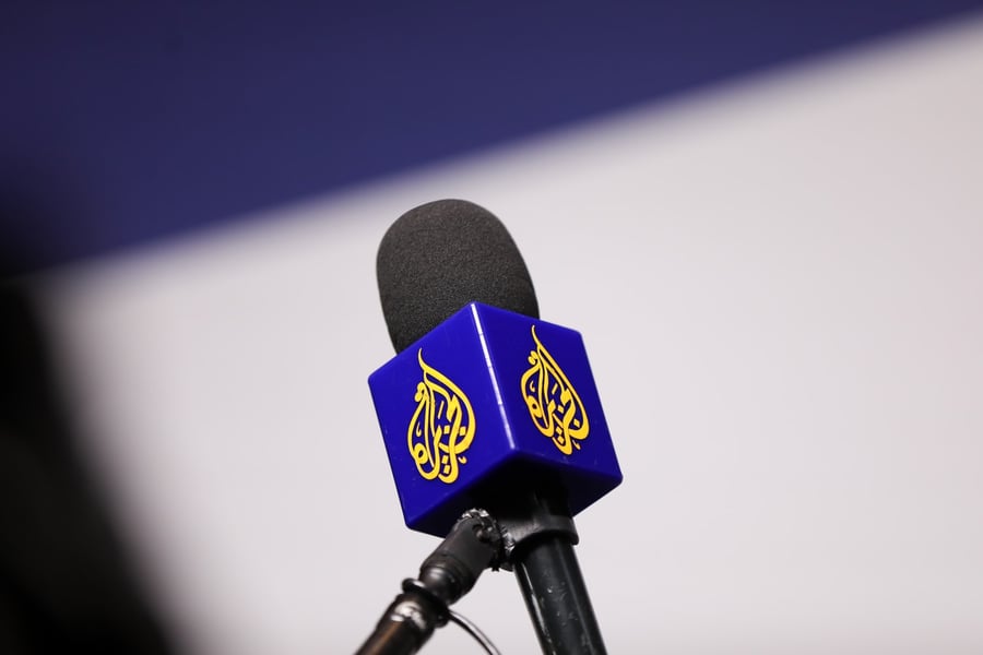 A microphone fitted with the Al Jazeera logo