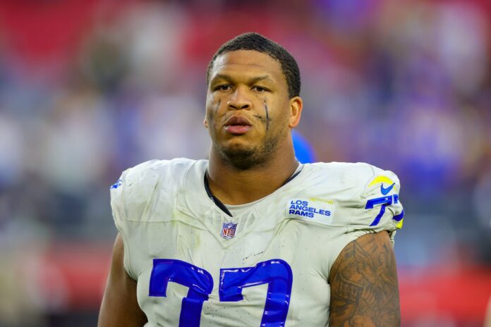 Los Angeles Rams left tackle Alaric Jackson in a white number 77 jersey after a game