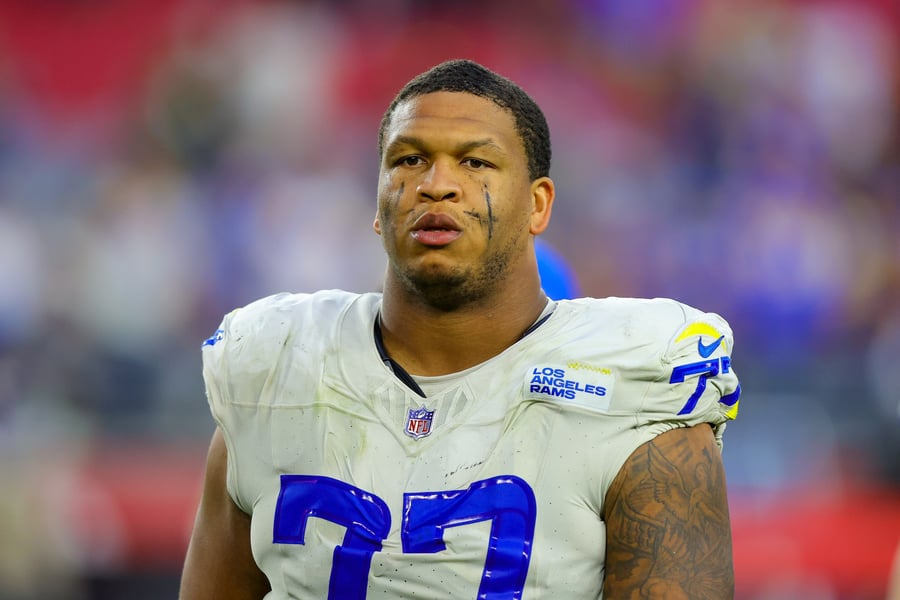 Los Angeles Rams left tackle Alaric Jackson in a white number 77 jersey after a game