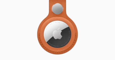 Apple AirTag shown with a FineWoven key-ring accessory in official promotional imagery