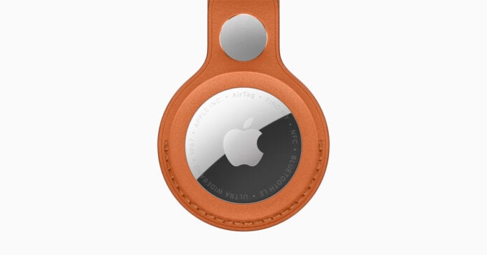 Apple AirTag shown with a FineWoven key-ring accessory in official promotional imagery