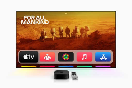 Apple TV 4K and Siri Remote in front of a television displaying the Apple TV interface