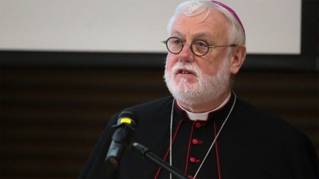 Archbishop Paul Richard Gallagher, the Holy See's Secretary for Relations with States, speaking at a microphone