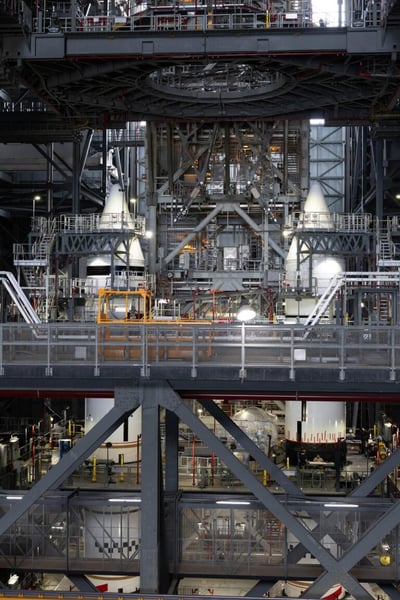 Twin solid rocket boosters for the Artemis III rocket stacked inside the Vehicle Assembly Building at Kennedy Space Center