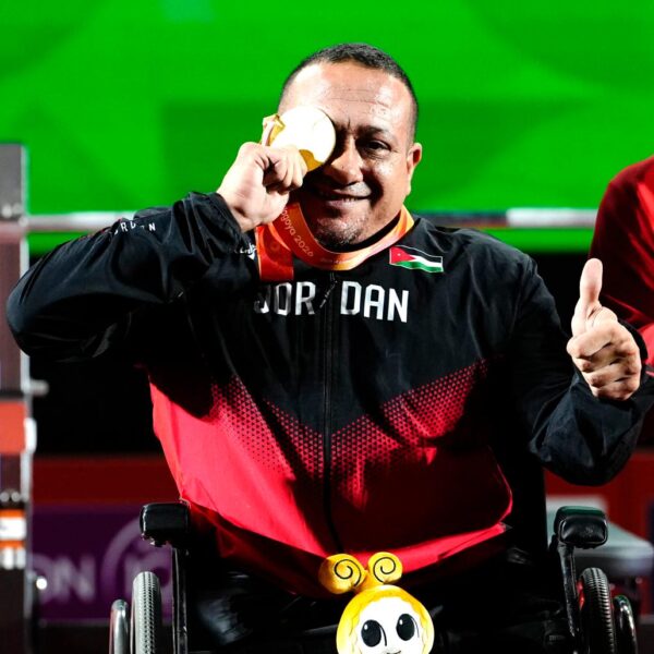 Jordan's Omar Qarada holds his gold medal to one eye after winning the men's up to 49kg Para powerlifting title at the Aichi-Nagoya 2026 Asian Para Games