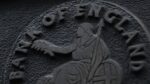 Close-up of the Bank of England emblem, showing the bank's name around the figure of Britannia