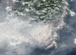 Satellite view of Borneo on October 15, 2026 with grey smoke over the south and red dots marking thermal anomalies detected by VIIRS