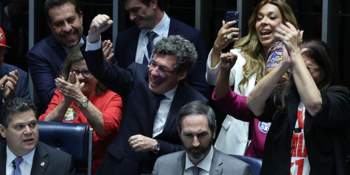 Senators in the Brazilian Senate raise fists and applaud after the vote ending the 6x1 work schedule