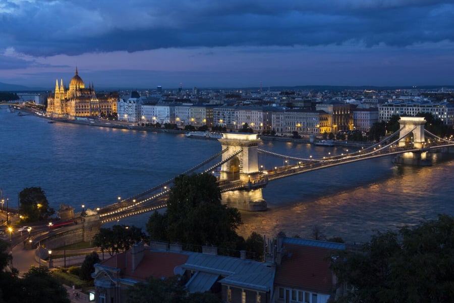 Budapest at dusk, with the illuminated Chain Bridge over the Danube and the Hungarian Parliament building at left