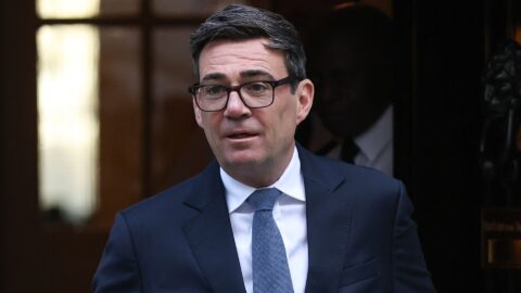 UK Prime Minister Andy Burnham, in glasses and a navy suit, leaves 10 Downing Street in London
