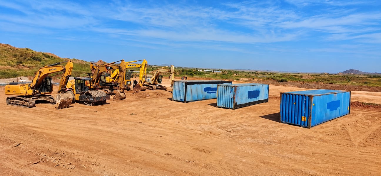 Construction Site with Excavators and Containers