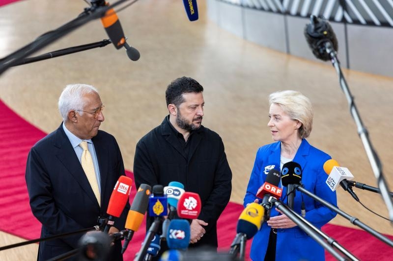 European Council President Antonio Costa, Ukrainian President Volodymyr Zelensky and Commission President Ursula von der Leyen stand before reporters' microphones in Brussels