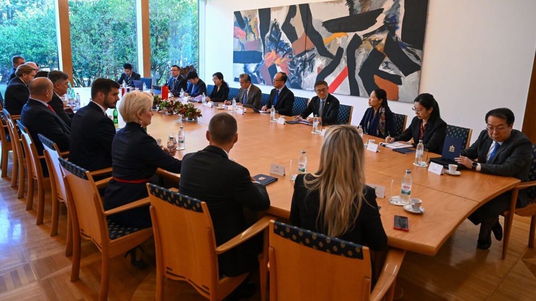 Croatian and Chinese delegations seated on both sides of a long wooden table during Wang Yi's visit to Zagreb