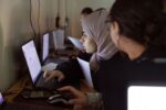 Young women working at laptops in a skills class in Damascus, Syria
